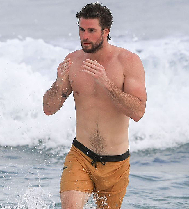 So far, they have managed to photograph his shirtless, and Liam Hemsworth’s...