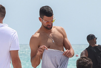 Novak Djokovic shirtless on a beach