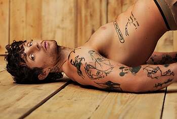 Tom Grennan posing shirtless