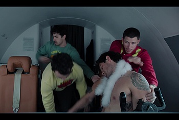 KJ Apa shirtless in A Very Jonas Christmas Movie