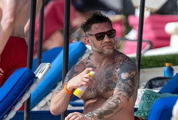 Tom Hardy shirtless on a beach