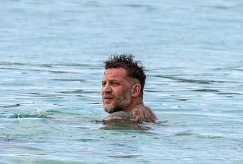 Tom Hardy shirtless on a beach