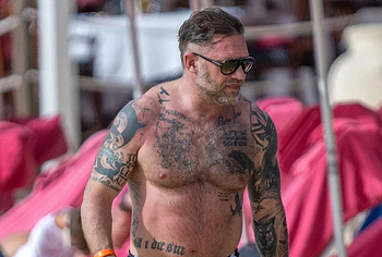 Tom Hardy shirtless on a beach