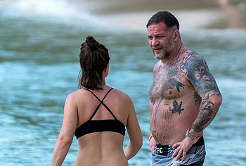 Tom Hardy shirtless on a beach