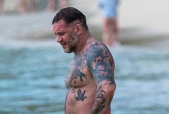 Tom Hardy shirtless on a beach