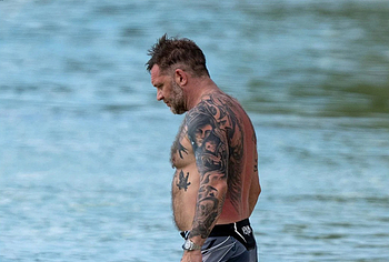 Tom Hardy shirtless on a beach
