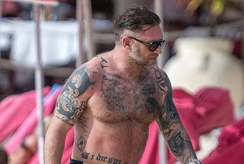 Tom Hardy shirtless on a beach