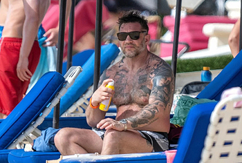 Tom Hardy shirtless on a beach
