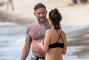 Tom Hardy shirtless on a beach