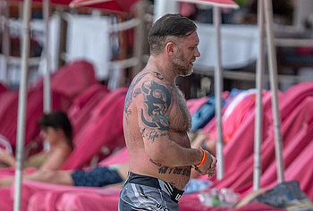 Tom Hardy shirtless on a beach