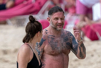 Tom Hardy shirtless on a beach