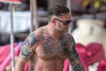 Tom Hardy shirtless on a beach