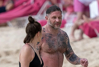 Tom Hardy shirtless on a beach
