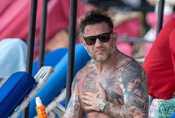 Tom Hardy shirtless on a beach