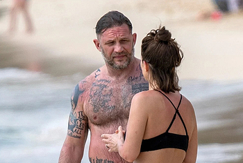 Tom Hardy shirtless on a beach