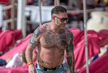 Tom Hardy shirtless on a beach