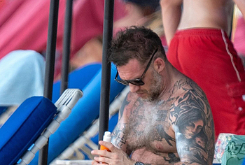 Tom Hardy shirtless on a beach