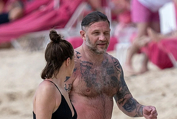 Tom Hardy shirtless on a beach
