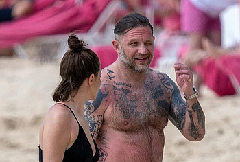 Tom Hardy shirtless on a beach