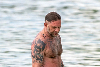 Tom Hardy shirtless on a beach