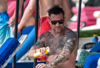 Tom Hardy shirtless on a beach