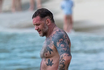 Tom Hardy shirtless on a beach